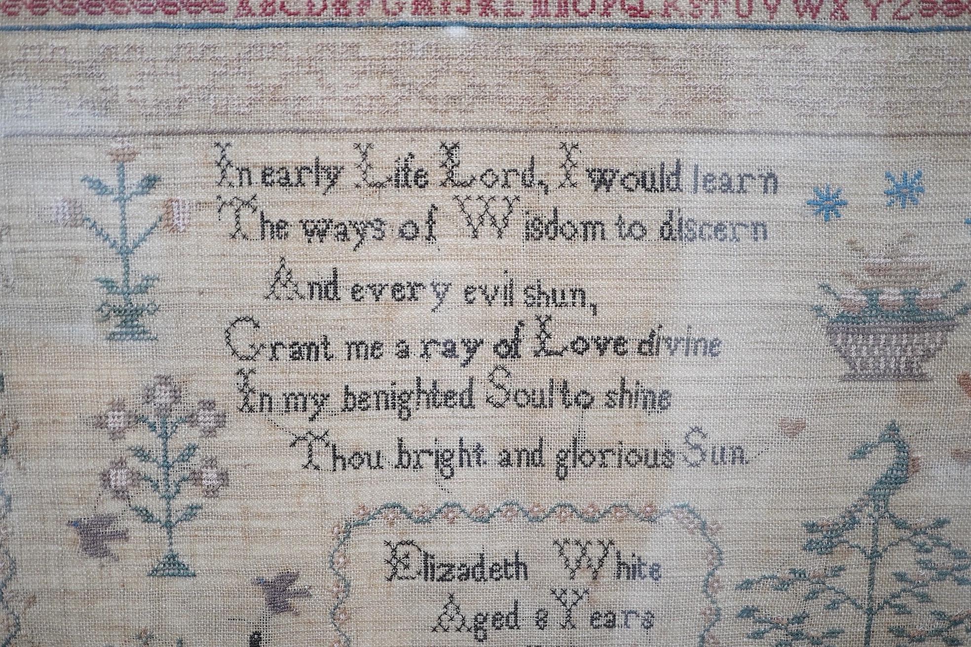 Two mid 19th century samplers worked by Elizabeth White, one dated 1842 aged 8 years, the other 1844 aged 11 years, both worked with a country scene of a house, birds, dogs and trees, the earlier sampler with a top panel